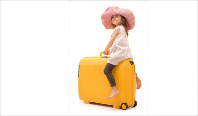 kid sitting on luggage 0